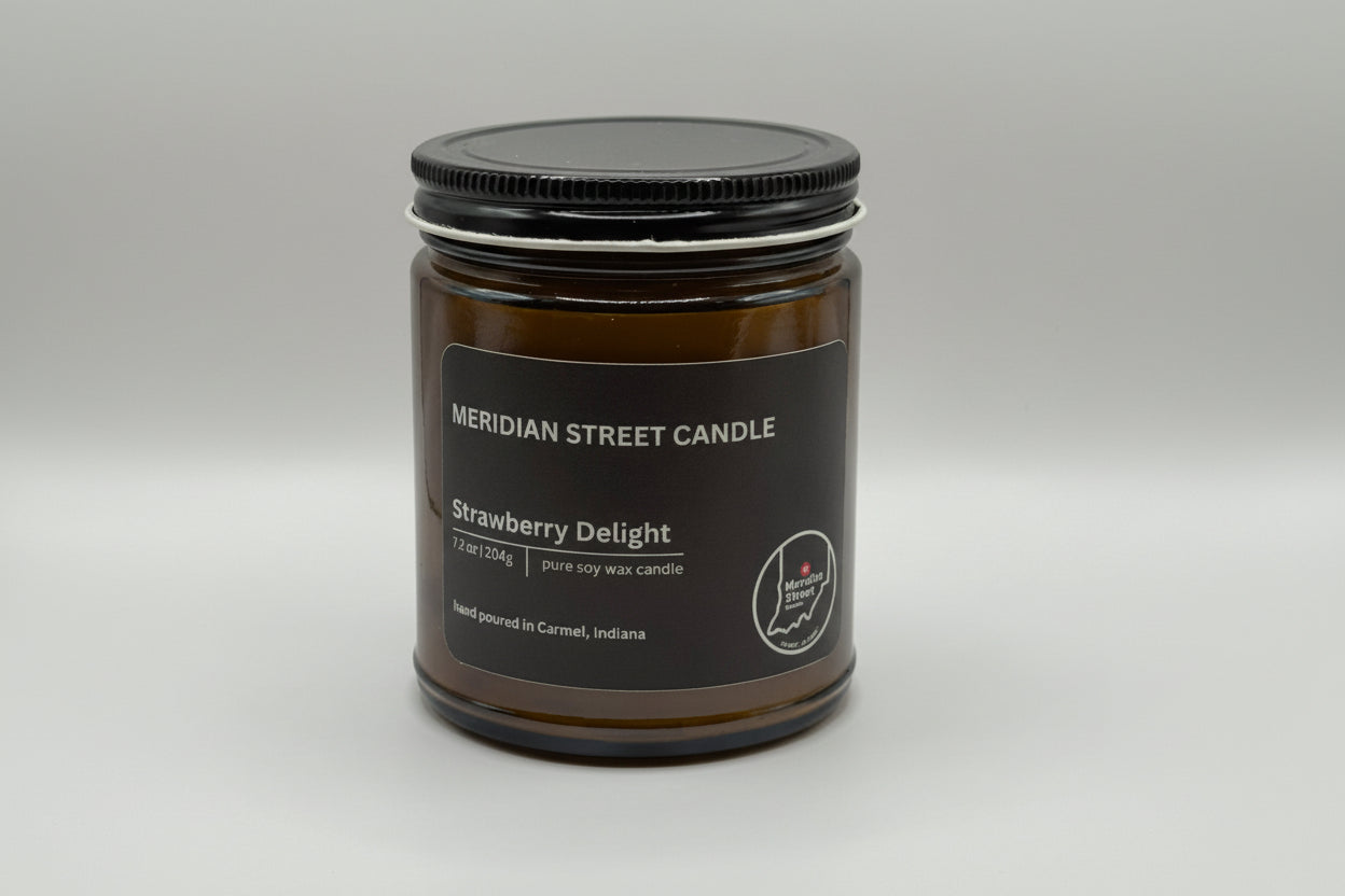 Meridian Street Candle jar labeled 'Strawberry Delight' on a gray background
