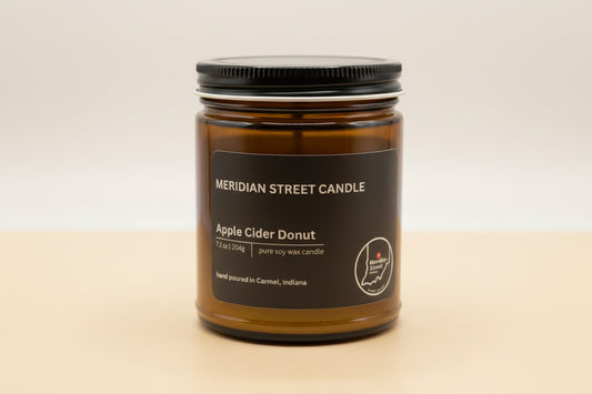 Meridian Street Candle jar labeled 'Apple Cider Donut' on a gray background