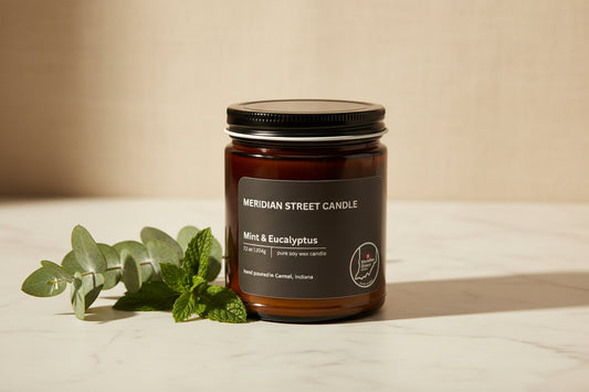 Black candle jar with 'Meridian Street Candle' label on a gray background